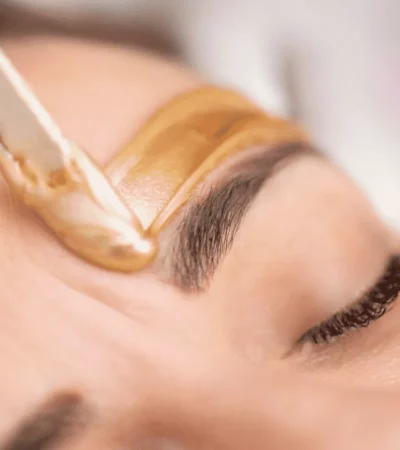 Femme se faisant épiler les sourcils à la cire